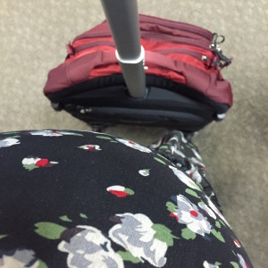 33.5 week along travel companion and I waiting to board our second flight. The bump is just about as big as my carry on, but they didn't charge me extra. ;)